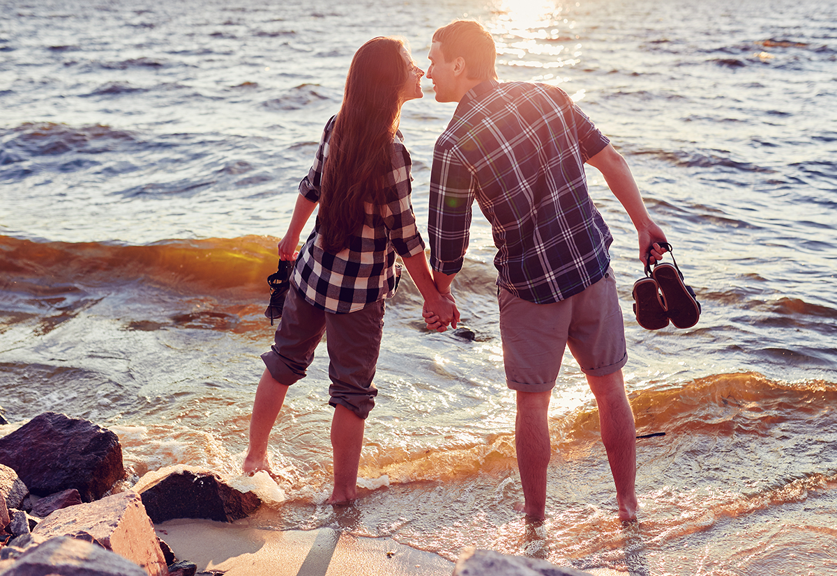 young-couple-love-sitting-park-ground-near-water_1200px